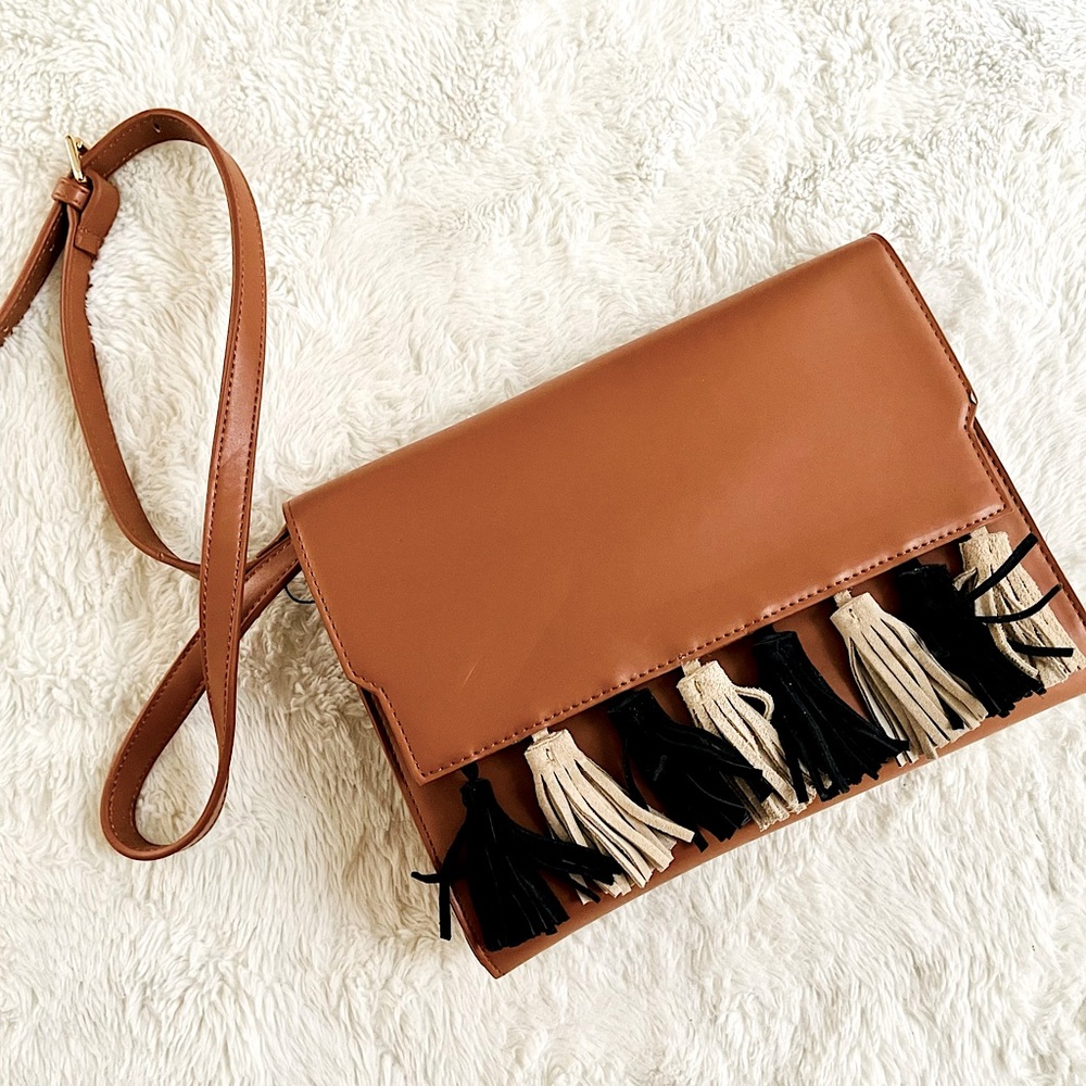 New boho inspired long strap purse cognac color with tan and black fringes.